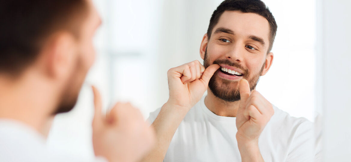 Man flossing teeth